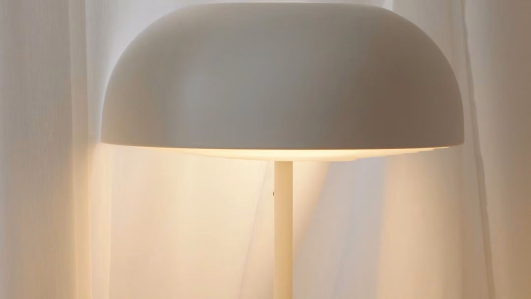 White dome lamp glowing warm white over a table